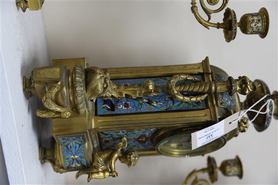 A third quarter of the 19th century French champlevé enamel and ormolu clock garniture, height clock 14in. candelabra 14.75in.